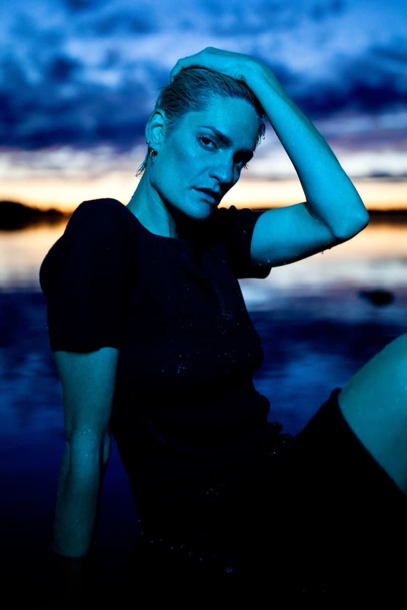 Seyblu sitting by the water at blue hour